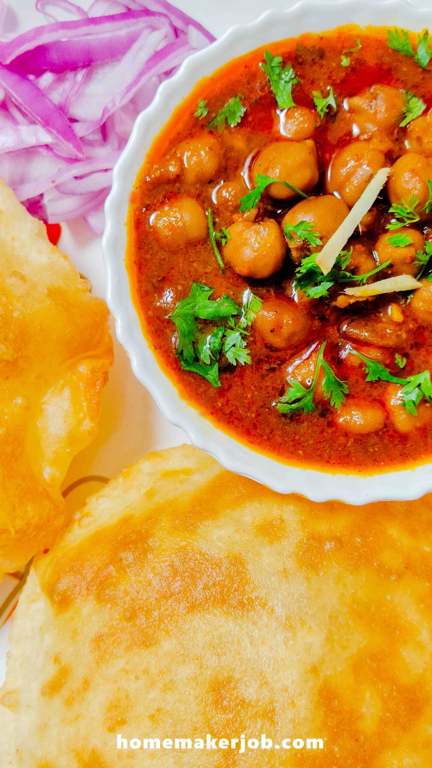 Chhole served hot with bhature and red onions in a white dish, by homemakerjob.com