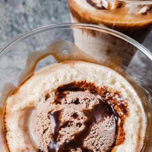 Top view photo of chilled chocolate milkshake with chocolate icecream at top and garnished with chocolate syrup, served in two glasses, a recipe by homemakerjob.com