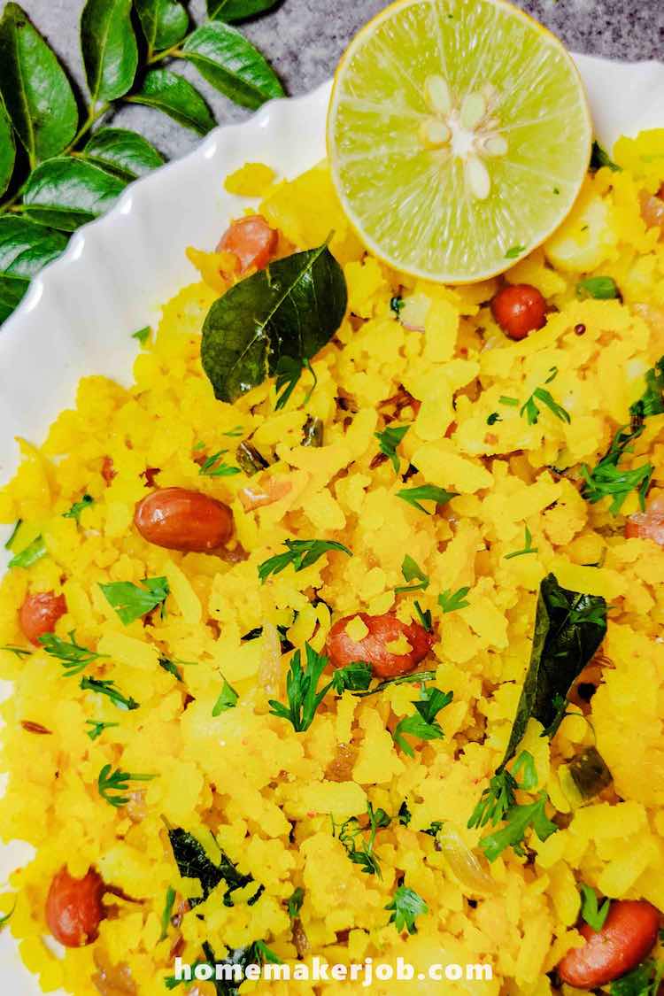 Tasty Poha served hot with half lime slice in a white dish, by homemakerjob.com
