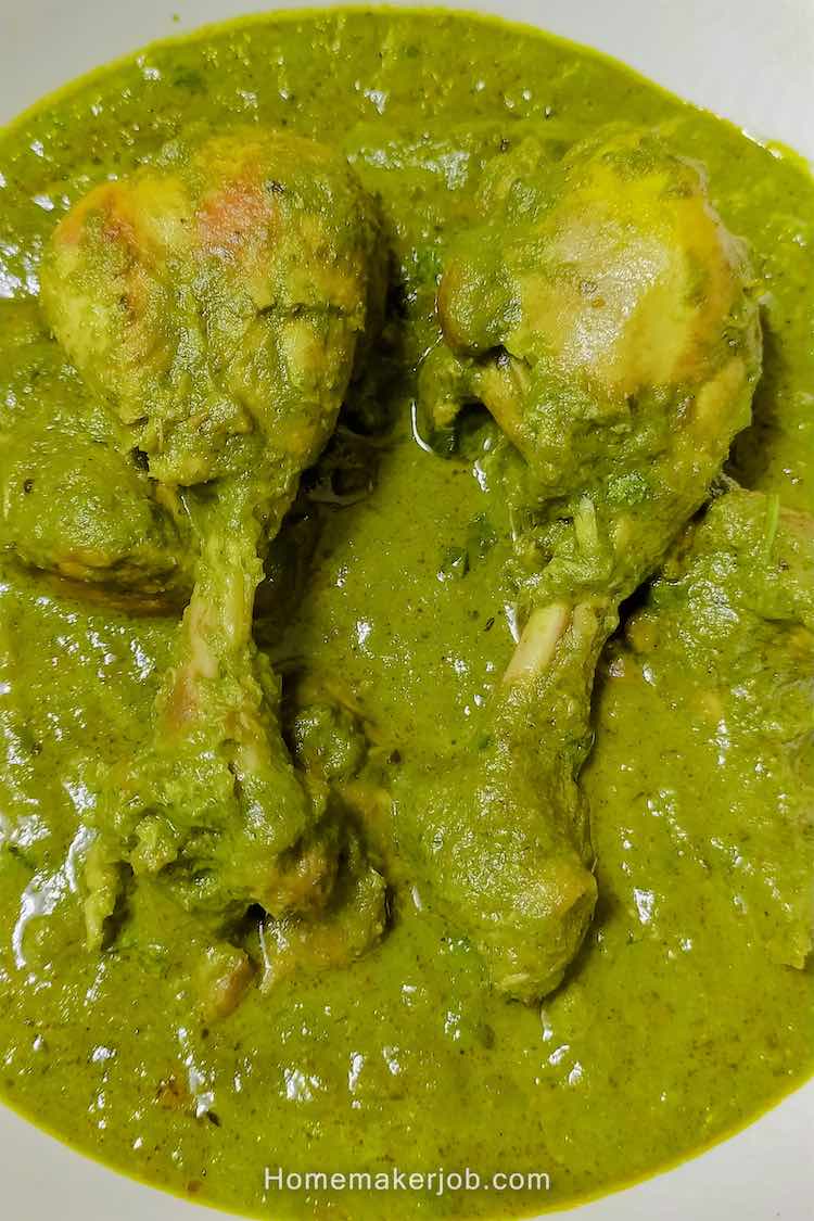 Close up shot of ready hot palak (spinach) chicken curry served in a white dish by homemakerjob