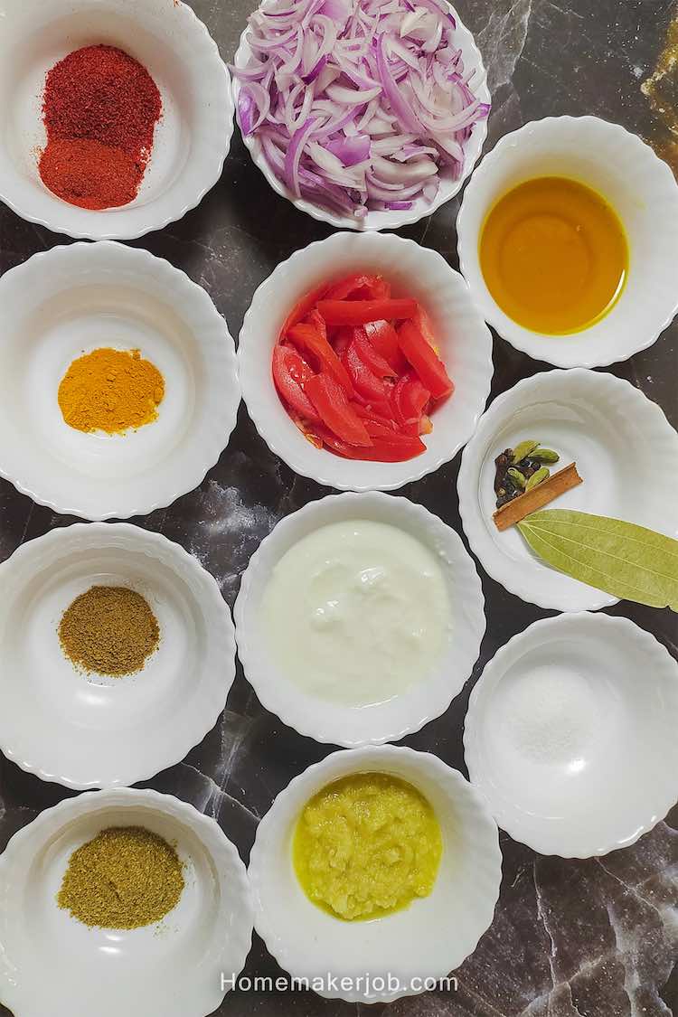 Photo of chicken kosha ingredients arranged in white bowls in matrix style by homemakerjob.com