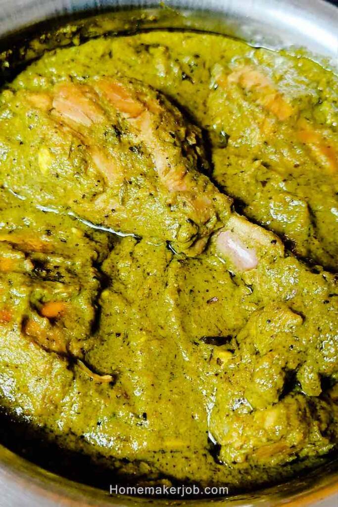 Close up photo image of ready hot Indian green (hariyali) chicken served in a white dish