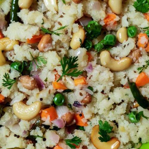 Close up photo of ready semolina upma served in a green plate on a table by homemakerjob