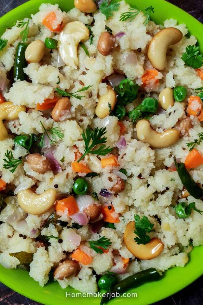 Close up photo of ready semolina upma served in a green plate on a table by homemakerjob