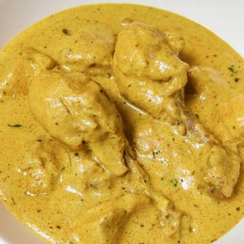 Ready hot reshmi chicken gravy served in a white dish on a table