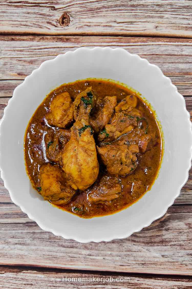 Ready hot chettinad chicken gravy served in a white plate on a table by homemakerjob.com