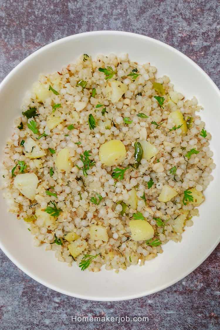 Close up photo of ready hot sabudana (sago pearls) khichadi served in a white plate by Homemakerjob