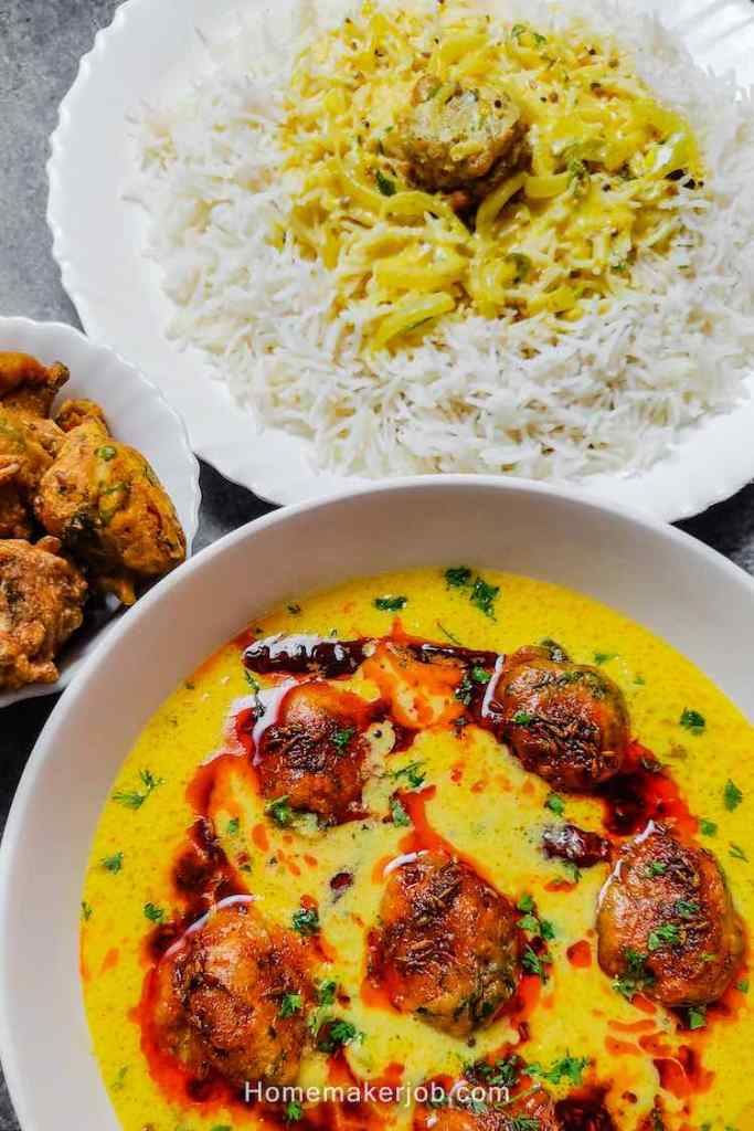 Close up photo of ready punjabi kadhi pakoda served with pakoras by homemakerjob.com