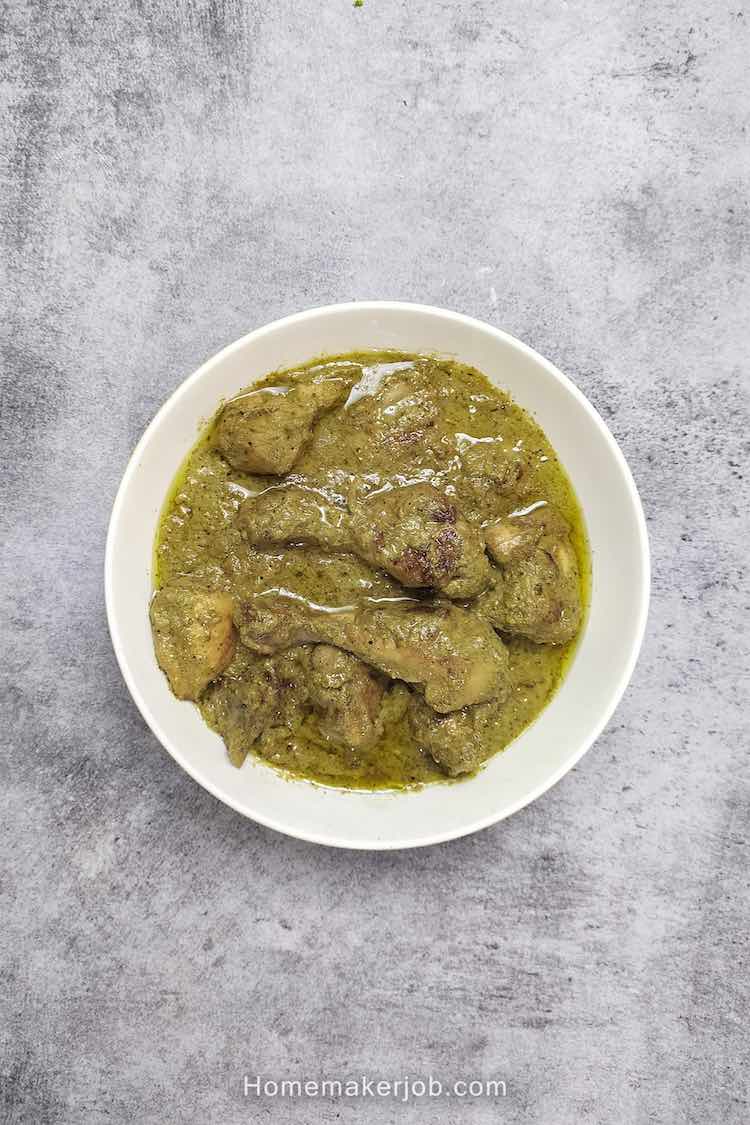 Ready afghani chicken curry served in a white bowl on a table top by homemakerjob.com