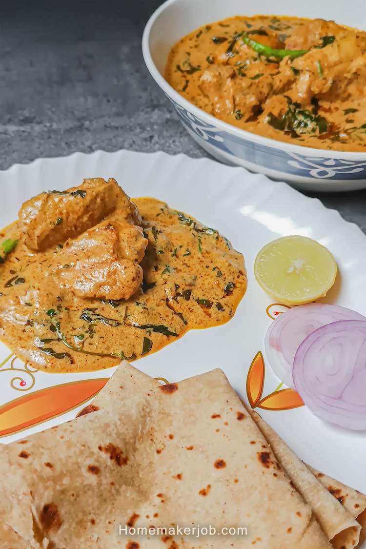 Murgh methi malai served hot with chapatis and garnished with onions, lemon; in a white dish on a table by homemakerjob.com