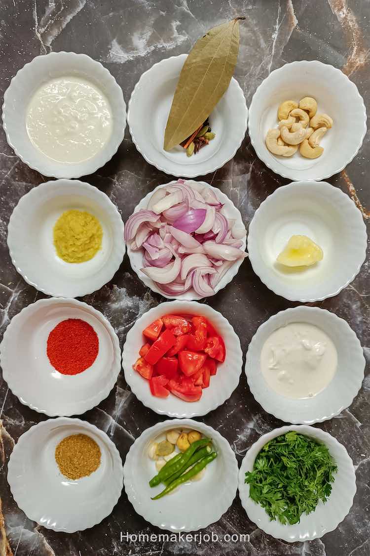 Methi malai chicken ingredient spices arranged in a matrix of white bowls on a table top by homemakerjob.com