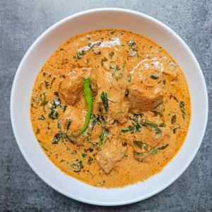 Ready tasty methi malai chicken served hot in a white bowl on table top by Homemakerjob,