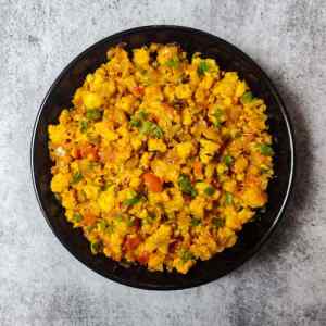 Ready hot restaurant style paneer bhurji dry served in a black plate on a table by homemakerjob