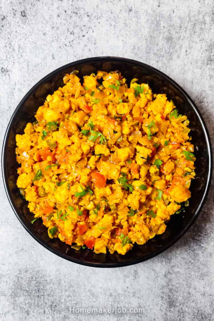 Ready hot restaurant style paneer bhurji dry served in a black plate on a table by homemakerjob