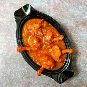 Chicken lollipop gravy served hot in a white dish on a table top, by homemakerjob.com