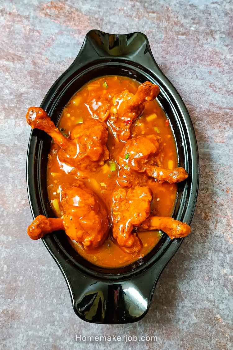 Chicken lollipop gravy served hot in a white dish on a table top, by homemakerjob.com