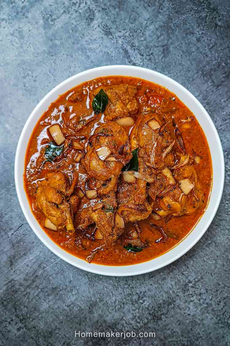 ready malabar chicken curry served hot in a white dish on a table top, by homemakerjob