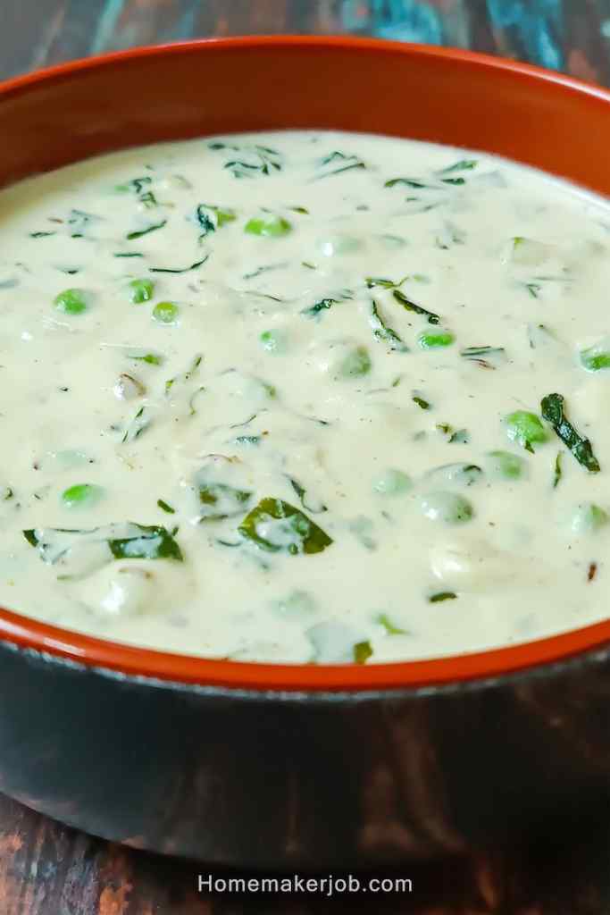 Close up photo of ready creamy methi matar malai served hot in a clay pot, on a table, by homemakerjob.com