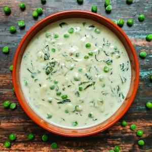 Ready creamy methi matar malai served hot in a clay pot garnished by matar beans around, on a table, by homemakerjob.com