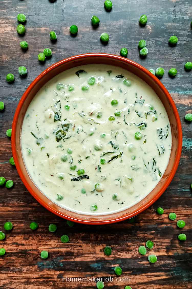 Ready creamy methi malai matar served hot in a clay pot garnished by matar beans around, on a table, by homemakerjob.com