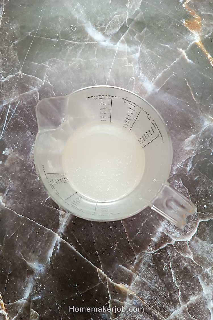 Corn starch slurry in a glass mug on table, for adding the slurry in lung fung soup made by homemakerjob