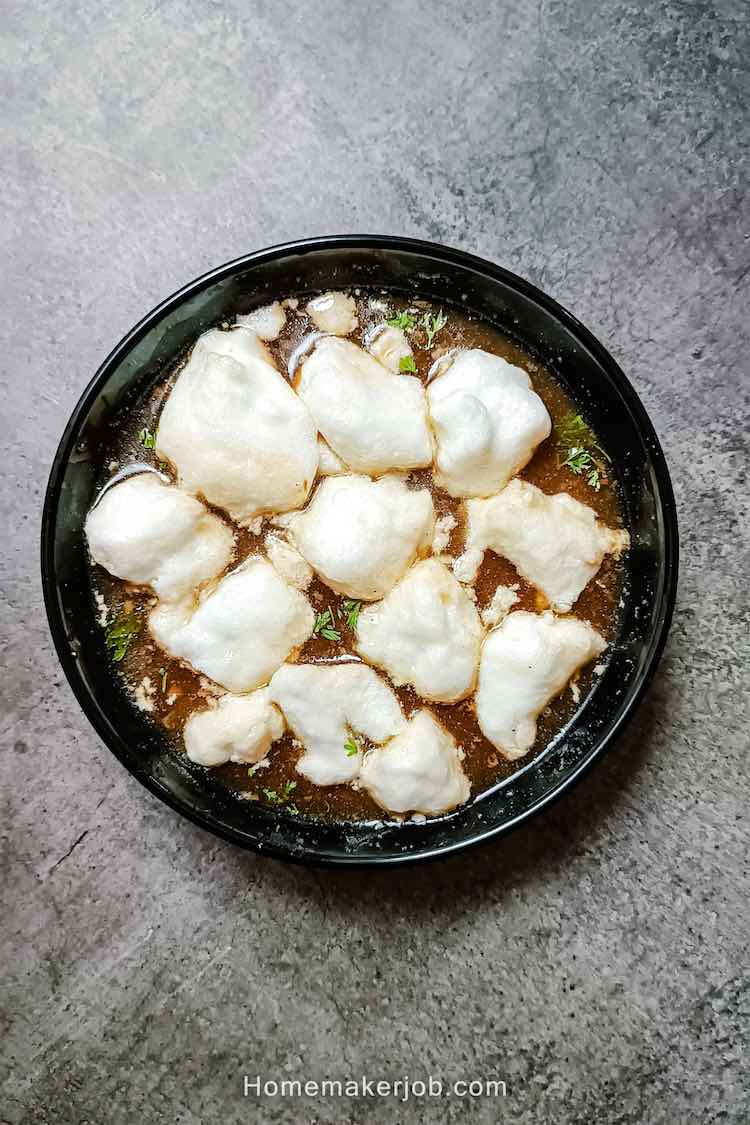 Top view photo of chinese chicken lung fung a.k.a. drgon phoenix soup served hot in a black bowl on a table; a recipe by homemakerjob.com