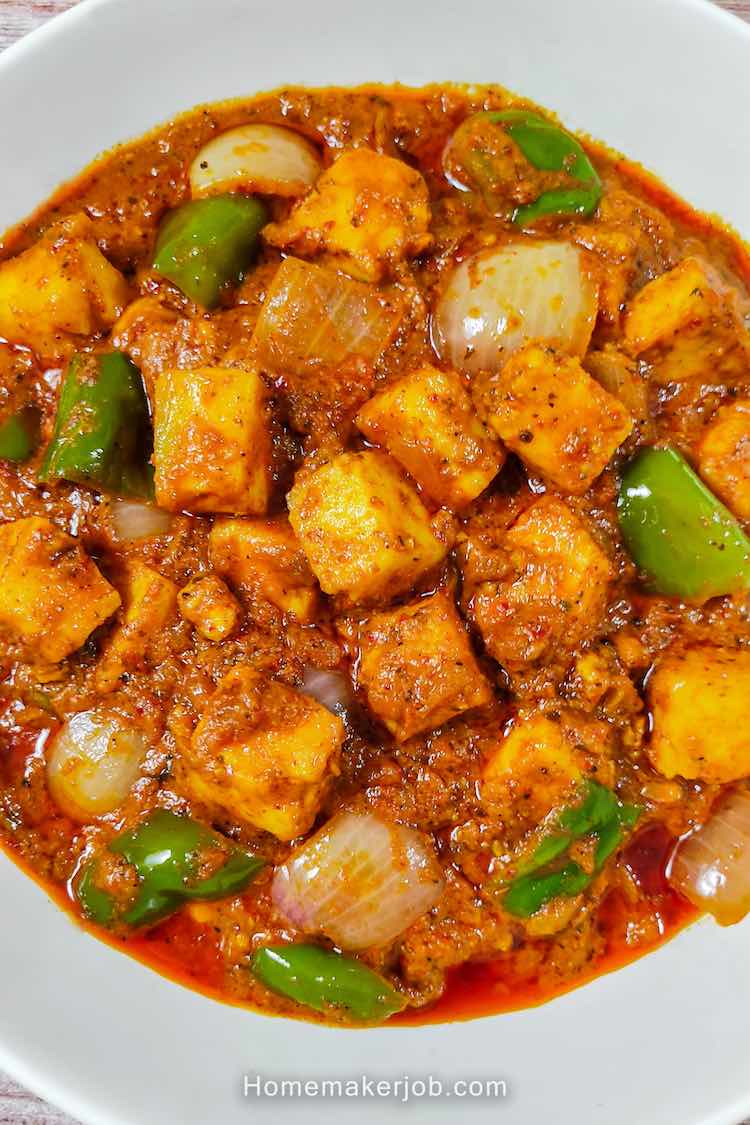 Top view close-up photo of restaurant style kadai paneer served hot in a white bowl, a recipe by homemakerjob.com