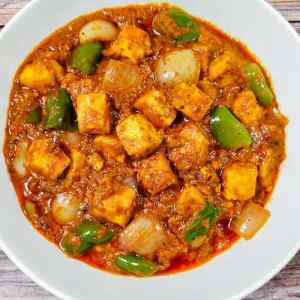 Top view photo of restaurant style kadai paneer served hot in a white bowl, a recipe by homemakerjob.com