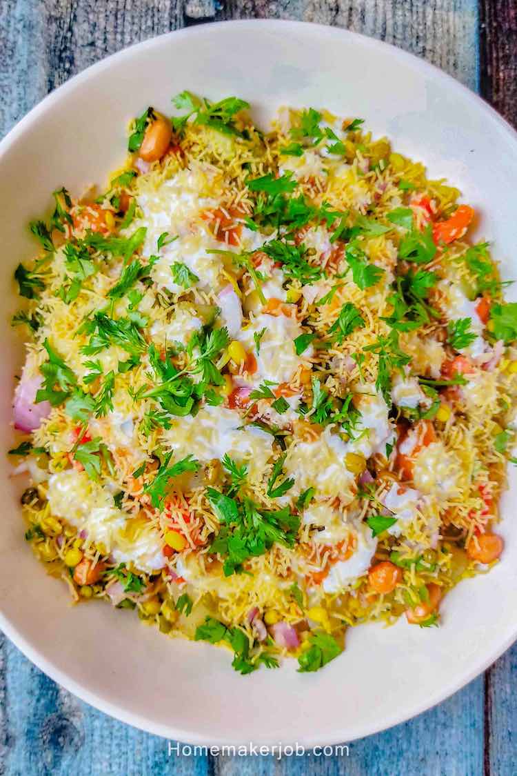 Top view photo of moong sprouts chaat served in a white bowl on a table, by homemakerjob.com