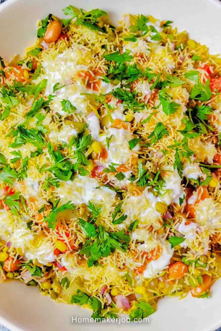 Top view close-up photo of moong sprouts chaat served in a white bowl on a table, by homemakerjob.com