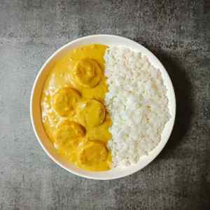 Top view photo of old fashioned curried eggs served along with white rice in white bowl on a table by homemakerjob.com