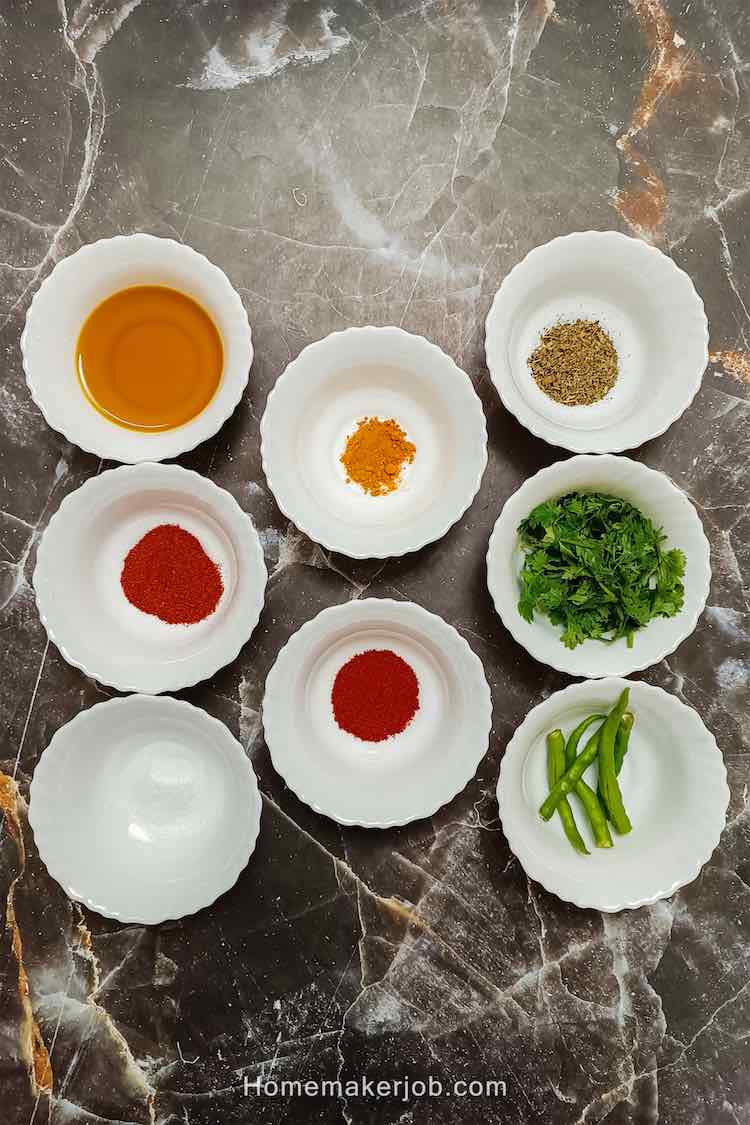 Photo of few remaining ingredients used in chicken rara, arranged in square matrix of white bowls. a recipe by homemakerjob.com