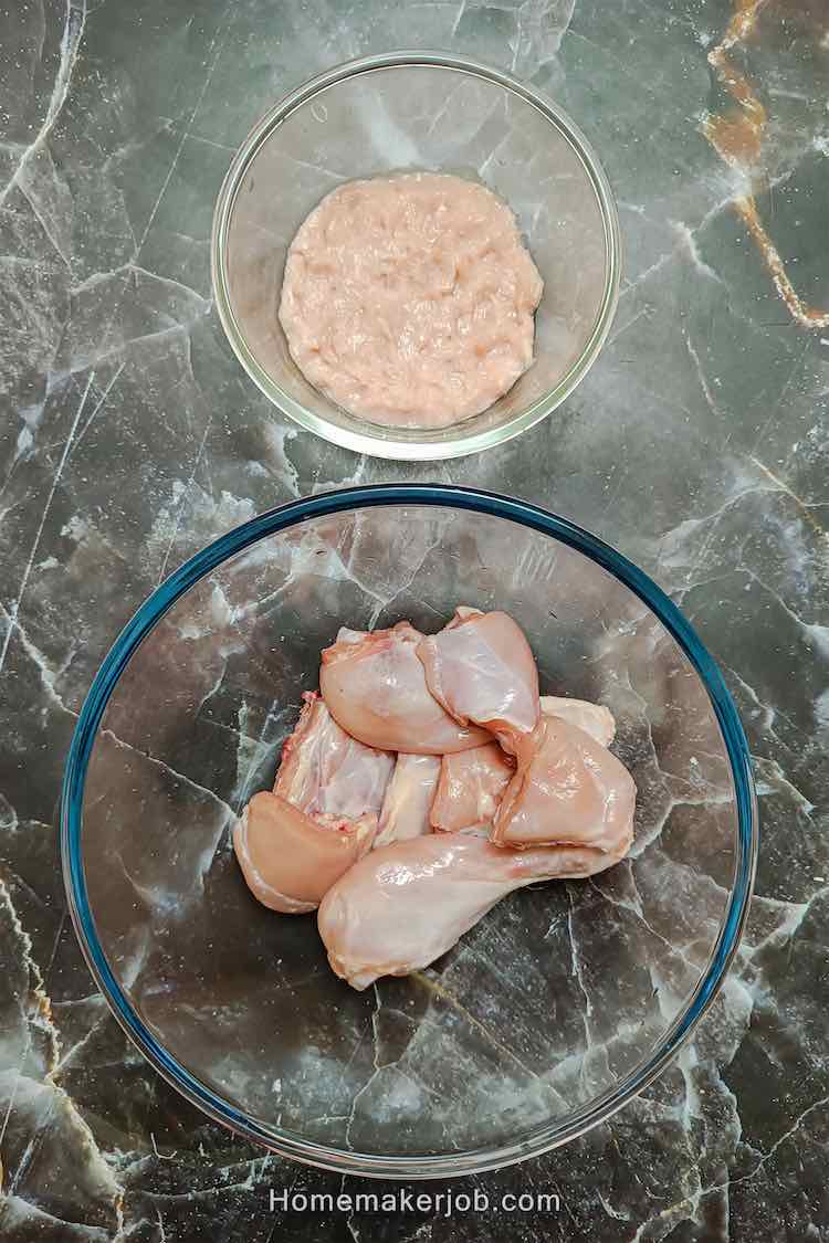 Photo of raw chicken in big glass bowl accompanied by chicken keema in another small glass bowl, to added as ingredient for chicken rara by homemakerjob.com