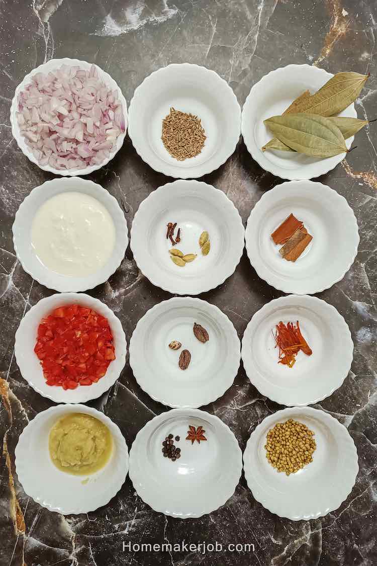 Photo of some of the ingredients used in chicken rara, arranged in square matrix of white bowls. a recipe by homemakerjob.com