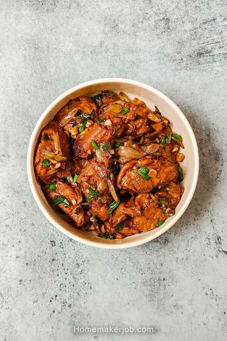 Top view of egg manchurian in a white bowl on a table top, a recipe by homemakerjob.com