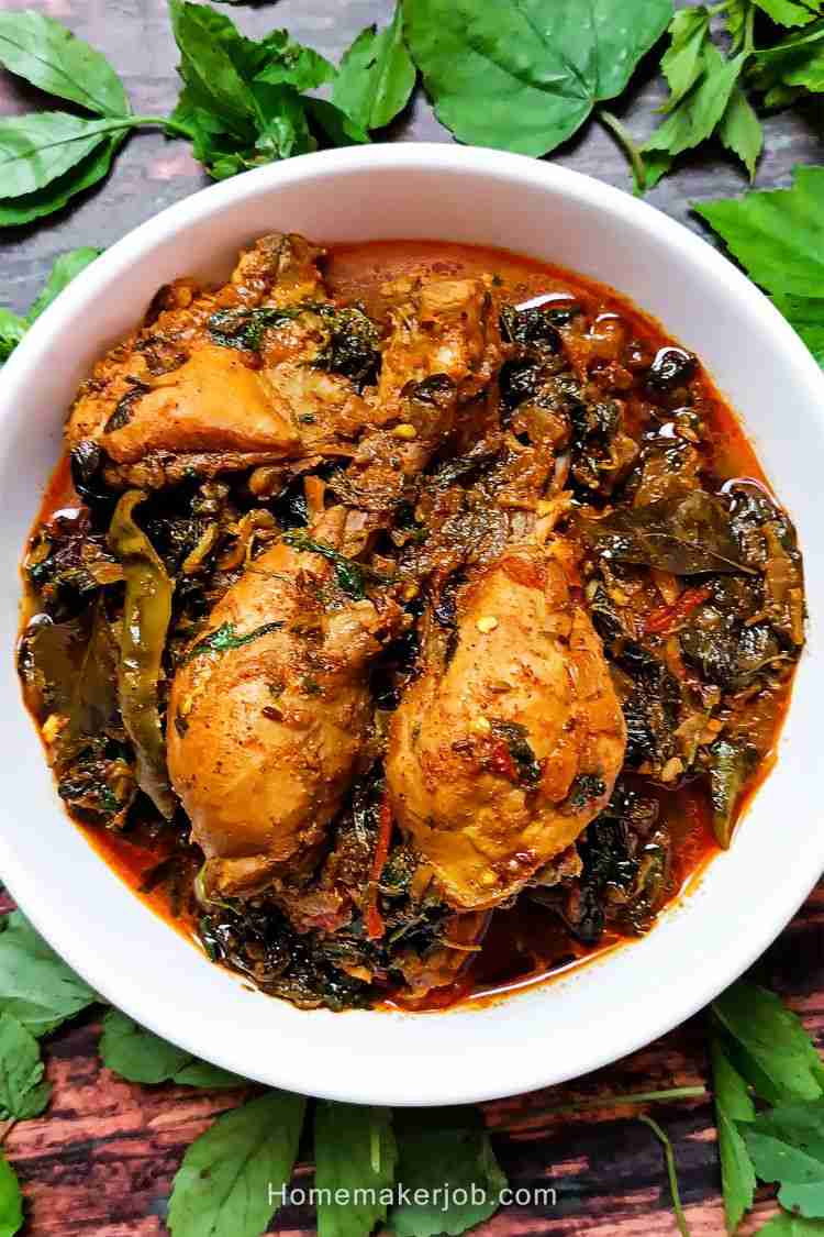 Top view photo image of gongura chicken curry gravy garnished with gongura leaves on table, by homemakerjob.com